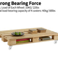 Pallet-style wooden coffee table on four swivel caster wheels with rubber rollers