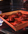 Heavy Duty Five Finger Oven Glove Pack Of 2 For Grillin And Barbecues handling cookie tray in an oven, heat resistant use.