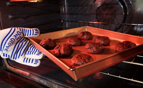 Heavy Duty Five Finger Oven Glove Pack Of 2 For Grillin And Barbecues handling cookie tray in an oven, heat resistant use.