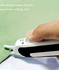 Close-up of Ultra Slick Cordless Electric Scissors for fabric cutting with safety design keeping fingers away from blades.