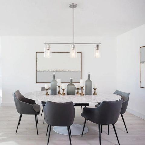 Three Light Modern Chandeliers For Kitchen Island Lighting In Brushed Nickel With Clear Glass Pendants in dining room setting.