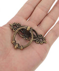 Set Of 6 Vintage Zinc Alloy Drawer Pulls And Retro Round Cabinet Knobs shown in hand, antique bronze finish