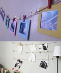 Photo display using clips and string with pictures and notes hanging on a wall, showcasing a creative decor idea.