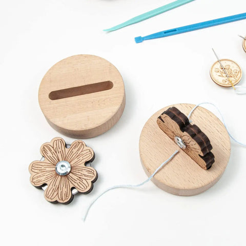Wooden Thread Cutter Blade For Sewing With Daisy Flower Design on a wooden base, showcasing sharp precision blade and non slip silicone feet.