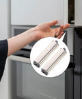 Hand using Hidden Cabinet Door Latch Four Pack Heavy Duty Push To Open Strong Touch Catch for cabinets and drawers, shown in use.