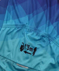 Blue cycling jersey with gradient pattern and safety distance icon showing 1.5m