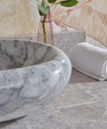 Sleek Marble Vessel Sink For Modern Bathrooms Featuring An Oval Countertop Basin Design displaying polished marble surface.