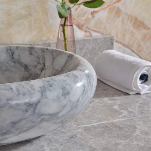 Sleek Marble Vessel Sink For Modern Bathrooms Featuring An Oval Countertop Basin Design displaying polished marble surface.