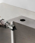Drill using Heavy Duty Carbide Hole Saw Kit For Stainless Steel With 7/8, 1 1/8, And 1 3/8 Inch Diameters on metal surface.
