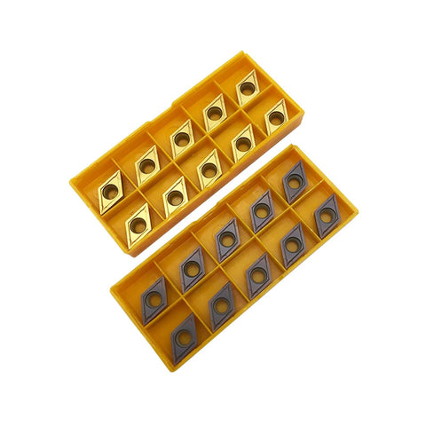 Front view: 20 DCMT turning inserts with gold/gray coating in yellow dual-tray storage boxes.