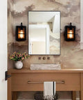 Set Of Two Farmhouse Wall Sconces With Modern Industrial Vibe, Matte Black Finish And Faux Wood Backing in bathroom