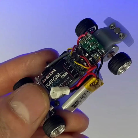 Hand holding 4 Channel Tiny RC Gyro Receiver For Mini Cars And Boats 1 28 Scale, highlighting compact design and components.