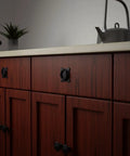 Premium Mission Style Wrought Iron Cabinet Ring Pull 2 Inch Antique Drop Handle With Matte Black Rust Resistant Powder Coat mounted on wooden cabinet.