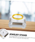 Didiseaon Solar Powered Rotating Jewelry Display Stand Decorative Rack for Watches Necklaces Bracelets showcasing a gold ring.