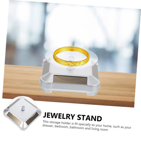 Didiseaon Solar Powered Rotating Jewelry Display Stand Decorative Rack for Watches Necklaces Bracelets showcasing a gold ring.
