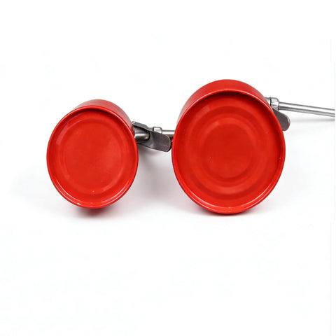 Two red metal hand oil cans with straight spouts and pump levers, placed side by side.
