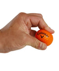 Hand holding an orange foam golf ball with HEX dimples, featuring the brand logo. Soft Flight Foam Practice Golf Balls 9 Pack Orange With HEX Dimples For Indoor And Outdoor Practice Safe Durable Balls To Sharpen Your Short Game And Swing.