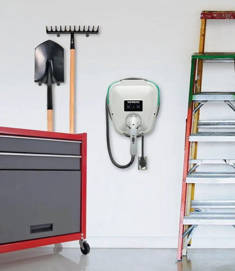 Badass Level 2 EV Charger Hard Wired With 30 Amp 240 Volt J1772 Compatibility mounted on garage wall with tools and ladder.