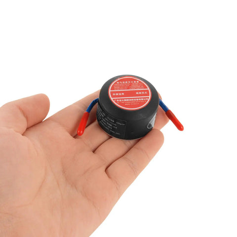 Person holding compact Automatic Aerosol Fire Extinguisher 10g With Back Adhesive Mount for vehicle engine bay