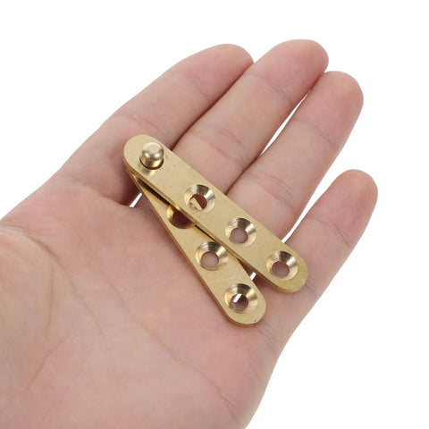 Two Pack Copper Concealed Door Hinges With Noise Reduction And Wide Rotation Angle shown in hand for size reference