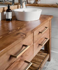 Wooden vanity with 5 Inch Antique Brass Cabinet Pull Handles, 6 Pack, Grooved Texture Non Slip Grip, installed in rustic bathroom.