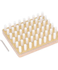 Wooden pegboard with white cylindrical pegs and an L-shaped allen key on the side, viewed at an angle.