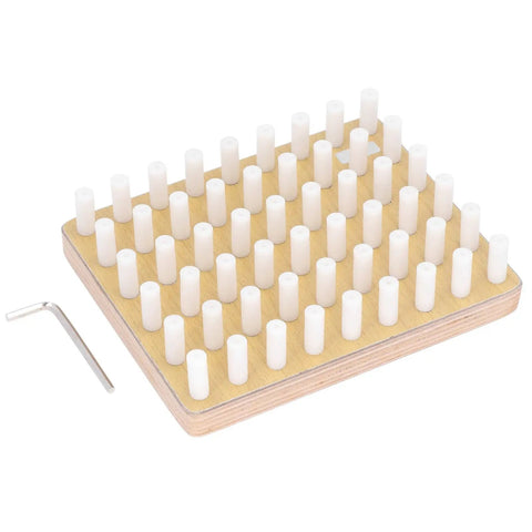 Wooden pegboard with white cylindrical pegs and an L-shaped allen key on the side, viewed at an angle.