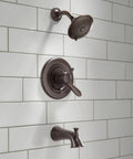 Lahara 17 Series Dual-Function Tub And Shower Trim Kit with 5-Spray Touch-Clean Shower Head in Stainless Steel installed on tile wall.