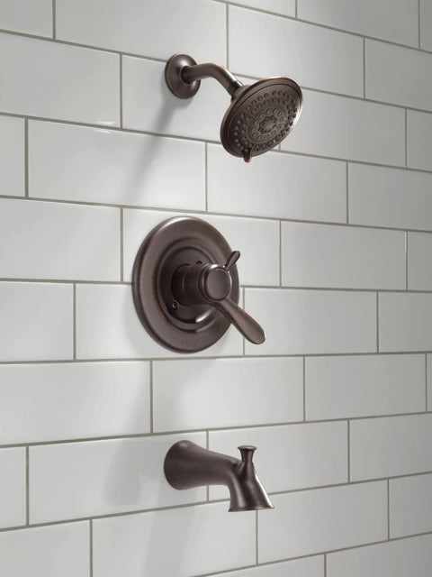 Lahara 17 Series Dual-Function Tub And Shower Trim Kit with 5-Spray Touch-Clean Shower Head in Stainless Steel installed on tile wall.