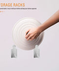 Hand placing lid on stainless steel wall mounted lid rack and cutting board holder for pan lids, moisture resistant.