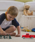 Child playing with 4.72 Inch Miniature Pickup Truck Model Alloy Metal Figurine For Collectors Who Dig, in room with toy soldiers.