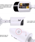 Realistic Fake Surveillance Camera 2 Pack With LED Light For Indoor Outdoor Security Dome Look Dummy CCTV Camera With Alarm Sticker Keeps Crooks Away White, showing batteries and rotation feature
