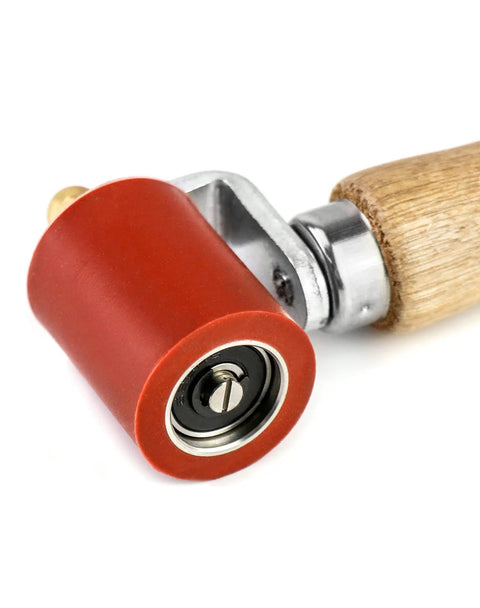 Close-up view of Silicone Seam Roller High Temperature Resistant Heavy Duty Pro Grade Hand Pressure Roller with wood handle and red silicone wheel.