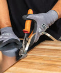 Using Left-Cutting Offset Tin Snips For Sheet Metal on a metal sheet, gloved hand making precise cut with beefy forged blades.