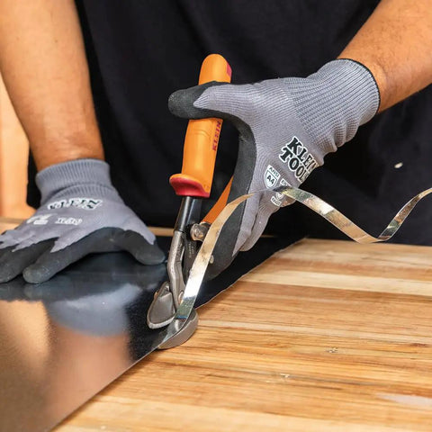 Using Left-Cutting Offset Tin Snips For Sheet Metal on a metal sheet, gloved hand making precise cut with beefy forged blades.