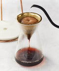 True Game Changer Ice Cold Brew Coffee Dripper Tower made of glass, showing coffee dripping into carafe with adjustable flow.