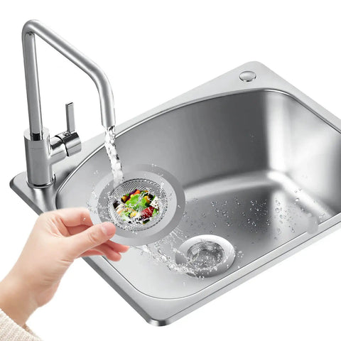 Person holding 2 Pack Stainless Steel Kitchen Sink Strainers With Large Wide Rim 4.5 Inch Diameter above a stainless steel sink
