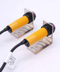 One Pair M18 Infrared Photoelectric Sensor With Through-Beam And Reflective Capabilities PNP No DC 6-36V 5m Sensing Distance Includes Mounting Bracket shown mounted.