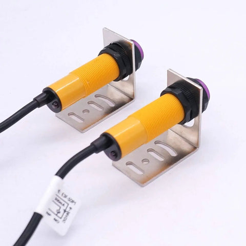 One Pair M18 Infrared Photoelectric Sensor With Through-Beam And Reflective Capabilities PNP No DC 6-36V 5m Sensing Distance Includes Mounting Bracket shown mounted.
