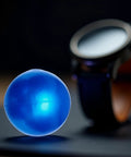Blue Rubber Ball Watch Case Back Opener For Battery Replacement, Non-Marking Friction Ball Tool, beside a watch