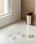 Heavy Duty Triple Ball Swivel Casters With Grippy Adhesive Mounts Quick No Drill Install for office furniture, three white casters on surface.