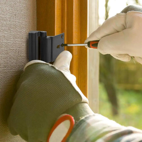 Person installing heavy duty 3 inch door reinforcement lock with 8 screw mounts that withstands 800 lbs of force on wooden door.