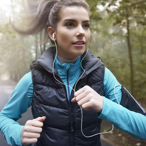 Woman jogging outdoors wearing white earphones, showcasing Two Pack USB C Headphones With Microphone And Volume Control, Durable Aluminum Casing.