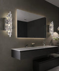 Crystal Chrome Wall Sconces for Living Room Bedroom Bathroom Hallway Staircase Lighting Indoor Vanity Wall Mount Lamps with Clear K9 Crystals, mounted on bathroom wall beside mirror