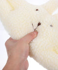 Hand holding a fluffy white door stopper for home and office soft durable wall protector that prevents finger pinching noise free door guard