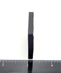 Side view of a 1.5-inch square silicone rubber stick-on foot bumper showing the thickness with a ruler for scale. Non-slip adhesive pad.