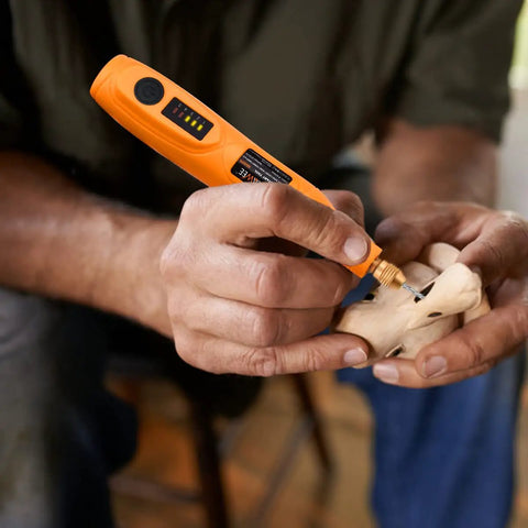 Person using Mini Cordless Rotary Tool Kit With 105 Accessories for wood carving at home
