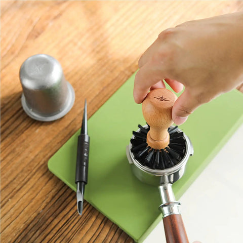 Hand using 58mm Portafilter Cleaning Brush For Espresso Machines Pro Barista Tool With Arc Bristle Design on portafilter