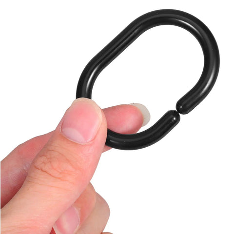 Hand holding black plastic C shaped shower curtain hook, part of Plastic C Shaped Shower Curtain Hooks Set Of 24 For Easy Glide In The Bathroom