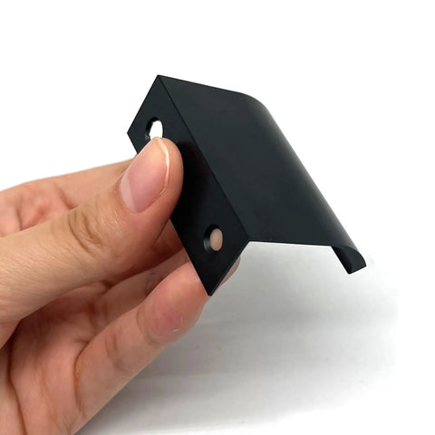Hand holding Six Pack 50Mm Drawer Pulls Matte Black Aluminum Cabinet Handles, showing sleek modern edge design and hidden mounting.